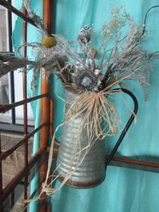 lot 140 image: Handled tin water can with wheat floral arrangement