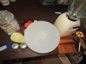 lot 192 image: Wooden napkin holder, measuring cups, white glass cake stand, salt&pepper shaker, spoon rest and more