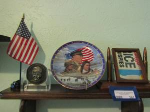 lot 241 image: Sam Walton Buisness leader award coin on stand,  American flag, D day June 1944-1994 American war plate, FRAME WITH 2 ARTILLERY SHELLS