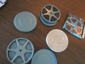 lot 295 image: Bell & Howell 200ft reels 1 is empty the others has the movie tape inside qty 5