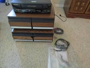 lot 321 image: 2 vhs tape holder boxes, SanSui vhs tape player with remote and power cords