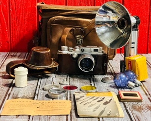 lot 116 image: Vintage Canon E-P Rangefinder Camera W 50mm F1.8 Lens, Leather Cases, Paperwork, Flash Unit, &amp Other Assesories- Made in Japan $$$