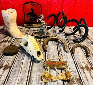 lot 182 image: Texas Comanche Pottery 7 Tall Swirl Etched Western Cowboy Boot Planter or Decor W Big Lot of Western Decor Including Coyote Skull, Horshoes, Wall Hanging Art, Solid Piece of Brass