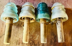 lot 37 image: Four Glass Insulators W Wooden Pegs for Telephone Pole -Whitall Tatum &amp Three Hemingrays
