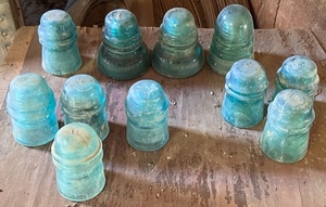 lot 35 image: 11 Green Glass Insulators - Brookfield, AM. TEL. &amp TEL, &amp Hemingray&nbsp