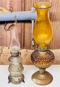 lot 276 image: Two Unique AntiqueVintage Kerosene Lamps- One With Amber GlassOne Shaped Like a Potbelly Stove