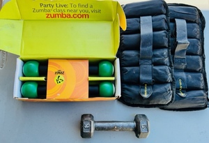 lot 77 image: New Zumba Exercise Equipment, One 5 Pound Dumbbell , &amp Two Golds Gym Leg Weights