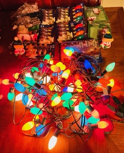 lot 256 image: Three Strands of Vintage Colored Christmas Lights W Generous Amount Of Replacement Bulbs, Hangers, and Ornaments