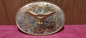 lot 189 image: Gold and Silver toned Longhorn belt buckle