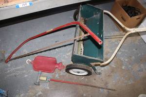 lot 136 image: Yard Spreader, Sprinkler Stake, Bow saw