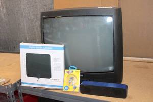 lot 53 image: Digital HDTV Antenna, Amplitude Aux-In Speaker, Metallic M&M Earbuds Unopened, and Philips TV Model 19PR21 C122