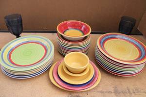 lot 60 image: Colorful Dish Set by Anfora, Royal Norfolk, and Brylane Home with Set of 4 Blue Goblet Glasses