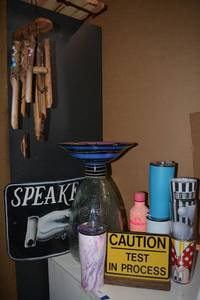 lot 147 image: Curved Speakeasy Sign, Decorative Glass Piece, Wooden and Bamboo Windchimes, and Travel Mugs