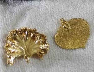 lot 249 image: Jewelry (2) 22K gold dipped leaves. Both intact.