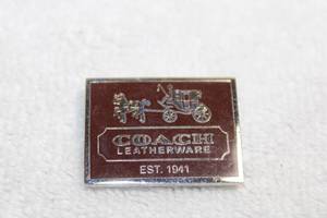 lot 265 image: Jewelry Coach magnetic logo
