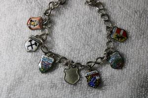 lot 37 image: Jewelry Sterling Silver 7L parallel link bracelet with 800 Silver German charms. Bracelet marked 925, Charms marked 800 REU, 800 EHJ, 800 SF and Antika