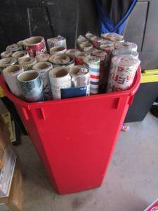 lot 57 image: red tub full of bran new Christmas wrapping paper qty 35 rolls