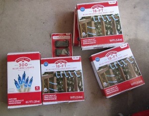 lot 58 image: Holiday time 300 mini blue Christmas lights new, 4 boxes of 18ft blue crystalized Christmas rope lights bran new, 2 packs of ornament hooks new