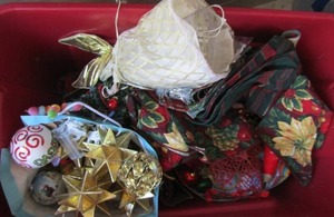 lot 112 image: red tub full of Christmas dcor like ornaments, angel, table place matts, garland