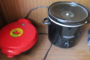 lot 118 image: black crock-pot with lid, red nostalgia electronics quesadilla maker