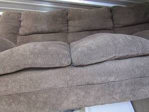 lot 12 image: Dark grey couch very light weight, used condition still has a lot of life left
