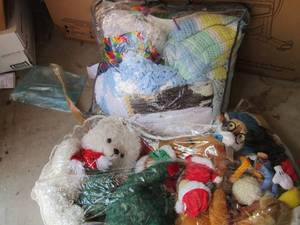 lot 159 image: Small plastic bag of stuffed animals, small bag of hand made baby blankets and throws