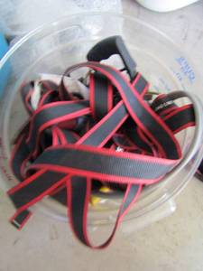 lot 170 image: clear bucket of tools, nails, tie down straps, and more