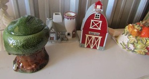 lot 49 image: green covered cookie jar, ceramic mother goose cookie jar, cookie barn and a fall covered cookie jar
