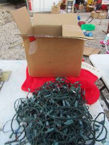 lot 224 image: Christmas lot includes 4 used stockings, Christmas lights, and light bulb hooks and Christmas bulbs