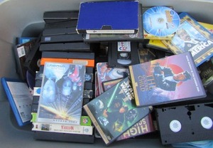 lot 223 image: tote full of vs. and DVD movies including Aladdin, the Incredibles, eddy murphy and more