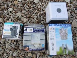 lot 229 image: angel wind chime new in box, artic air purifier, intext inflator new in box, and a motion security light