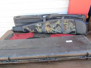 lot 249 image: 2 black gun cases one has animals and forest design on one side, a black and red gun bag and a zip up camouflage mossy oak rifle bag