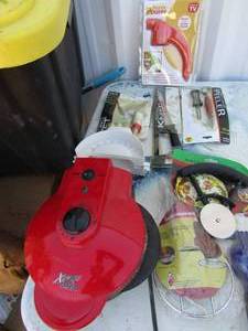 lot 261 image: Kitchen lot includes, handy helpers, icing set, fruit carverpeeler, frozen food knife, express ready set go sandwich maker, pizza cutter, pie maker, all new except the sandwich maker