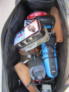 lot 23 image: Black carry bag full of shoe shine items and brushes