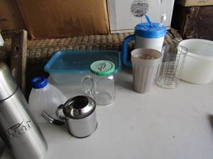lot 112 image: kitchen lot of cups and some Tupperware all used a few tumblers included