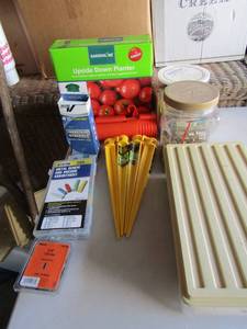 lot 116 image: Garden line upside down planter, tub of 2 screws, box of various match books, tent spikes,