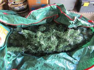 lot 152 image: 6ft green Christmas tree, comes in bag with stand, pre lite unknown if lights work, good condition