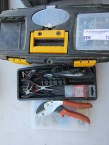 lot 15 image: small black tool box full of wiring accessories, plyers, ward wire cutters, new packs of screws and bolts, small nails