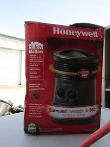 lot 7 image: Honeywell 360 full turn around heater, has 2 heat settings and adjusable thermostat, unknown working  condition preowned