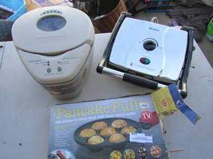 lot 154 image: Haiser indoor electric grill looks new, west bend bread maker new, pancake puffs maker it makes, carmel apple, sausage, chocolate, strawberry cake puffs and more NIB