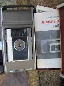 lot 161 image: RCA camcorder in carry bag, poloroid land camera model J66 in case with paperwork extra flash and lens plus new box of flash bulbs