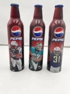 lot 96 image: Selection of 3 metal football player Pepsi bottles - unopened, 1 is almost empty