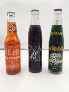 lot 102 image: Selection of 3 vintage soda bottles, Nehi, Delaware Punch, and Nugrape - unopened