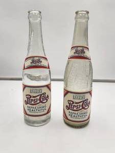 lot 104 image: Selection of 2 vintage empty Pepsi bottles