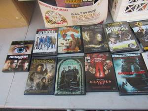 lot 75 image: GE digital dvd player, large lot of DVDs including scary, love and romance, many more