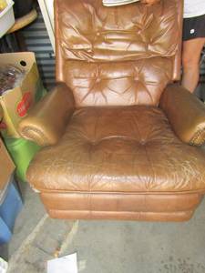lot 139 image: Older brown leather reclyner has small front damage like a tear
