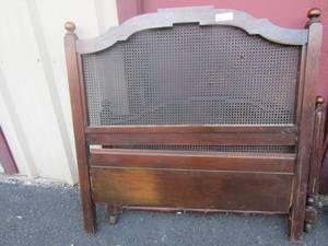 lot 143 image: MCM Twin size head  and foot  board with side rails one end is damaged in middle where the wicker is at
