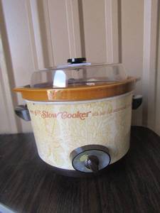 lot 169 image: New crock pot with all pieces and comes with a crock cook book