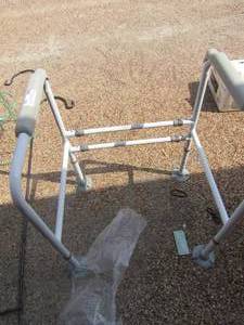 lot 180 image: new toilet handrails that sits over and around the house commode, weight capacity is 450 LBS.  Has rubber stops on bottom to keep from moving