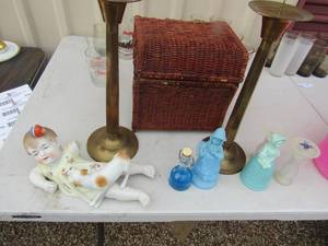 lot 231 image: wicker basket with lid, baby and her dog with a broke arm, 12 brass candle holders, various perfume bottles from avon